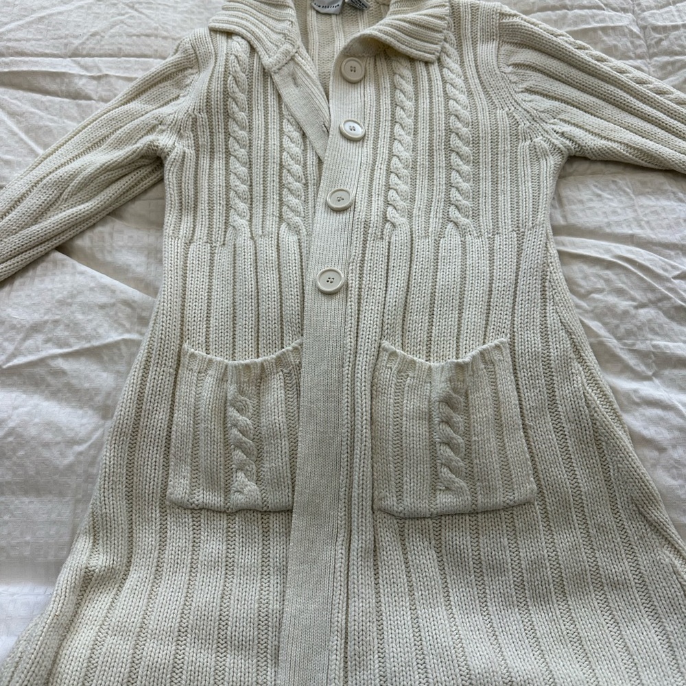 Long cardigan type. A bit pilly and sleeves have some discoloration. But cozy.